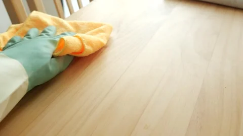 Cleaning a wooden table using a microfiber cloth Stock Footage 317527538