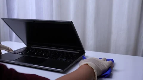 Cleaning the work table with alcohol spray and medical gloves in hand Stock Footage 274468425