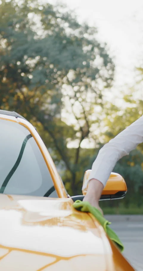 Cleaning a Yellow Car Stock Footage 319350231