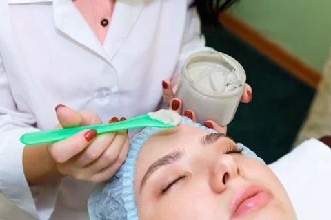 Cleaning your face with a scrub. The concept of facial skin care. Stock Photos
