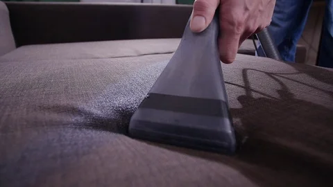 Cleanliness concept. Dry cleaning worker removing dirt from upholstered Stock Footage 124678978