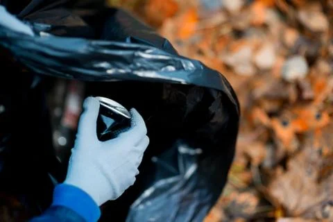 Cleanliness before a snowfall. Collection of various garbage in a garbage bag Stock Photos