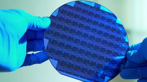 Cleanroom tech handling a silicon wafer of microchips 4k Stock Footage