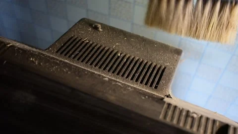 Cleans the back of an old TV Stock Footage 138400063