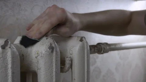 Cleans the battery of rust with sandpaper Stock Footage 116129226