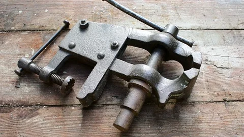 Cleans up bench vise off the table Stock Footage 116543484