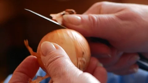 Cleans the onion with a knife Stock Footage 88713832