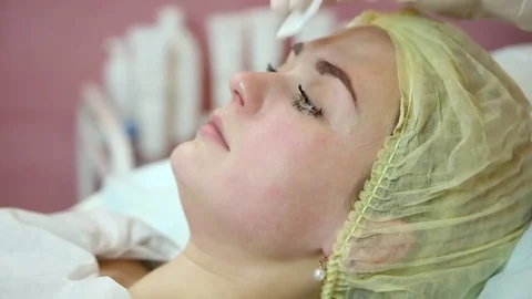 Cleansing the face using cotton pads Stock Footage 83499913