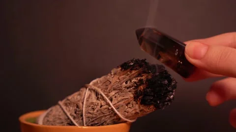Cleansing smoky quartz crystal point with white sage smoke Stock Footage 230048003