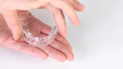 Clear aligners demonstration Clear aligners for teeth straightening on hand Stock Footage 318673588