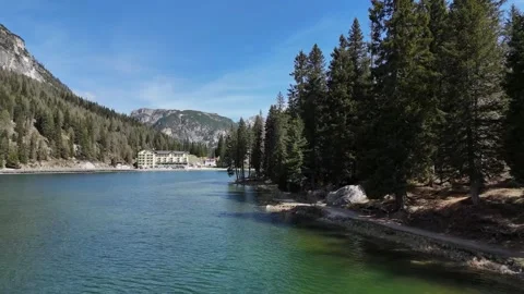 Clear Alpine Lake Framed by Shoreline Pines and Mountains Stock Footage 341650880