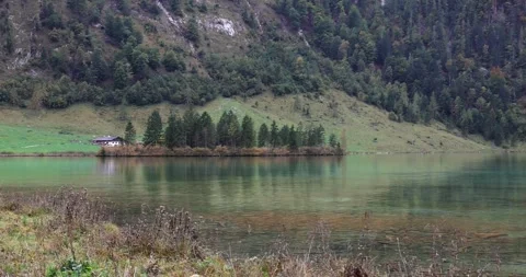 Clear alpine lake with mountain reflections Stock Footage 340486388