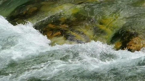 A clear and cold river flows in Austria Stock Footage 104669847