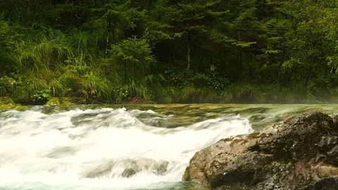 A clear and cold river flows in Austria Stock Footage 104670077