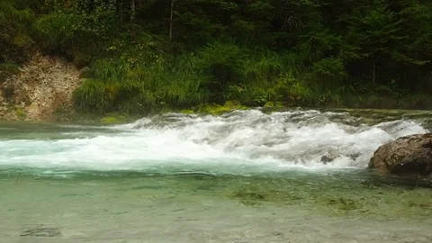 A clear and cold river flows in Austria Stock Footage 104671600