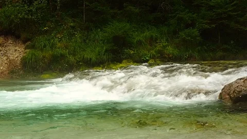 A clear and cold river flows in Austria Stock Footage 104672775