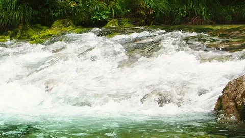 A clear and cold river flows in Austria Stock Footage 104673234