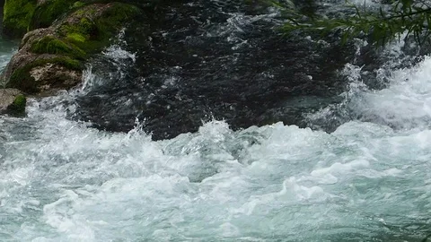 A clear and cold river flows in Austria Stock Footage 104673288