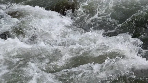 Clear and fast flowing rocky mountain river Stock Footage 320982571