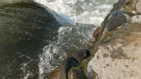 Clear and fast flowing rocky mountain river Stock Footage 320982622