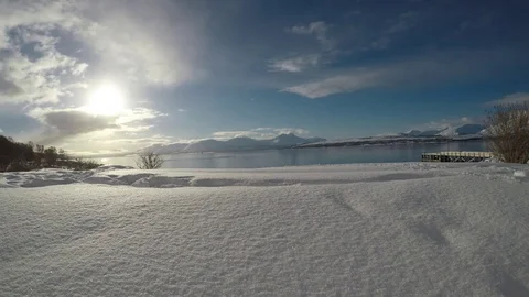 Clear and pristine snow patch on small hill with golden sunshine and blue sky Stock Footage 72951186