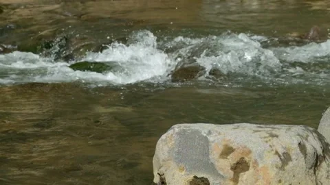 Clear and rocky mountain river scenery Video stock 320923097