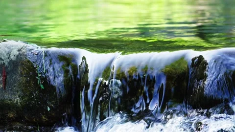 Clear and transparent spring water flows on the rocks Stock Footage 235780814