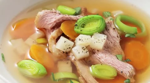 Clear beef broth with garnish Stock Footage 24662956