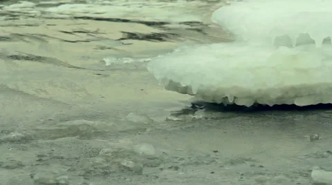 Clear block of ice lying on the sand beach 스톡 동영상 55425344