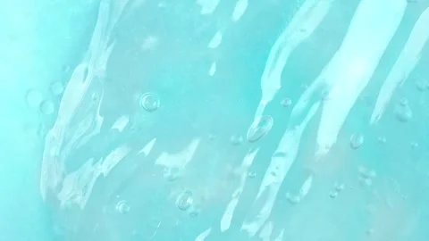 Clear blue gel fluid with bubbles, rotating. Macro texture of cosmetics produ Stock Footage 276481673