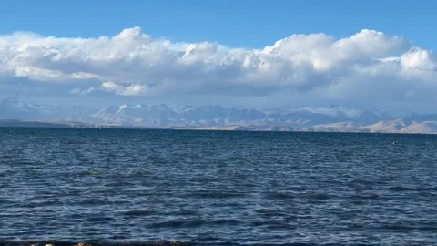 Clear Blue Lake with Snow-Capped Mountains and Clouds on Tibetan Plateau, Tibet Stock-Footage 336757118