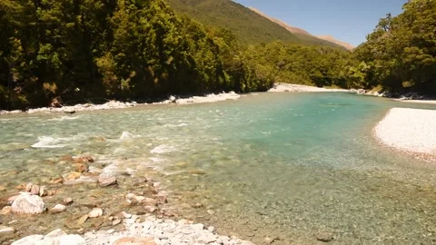Clear, blue, mountain river flowing over a stony bed, New Zealand. Stock Footage 146286748