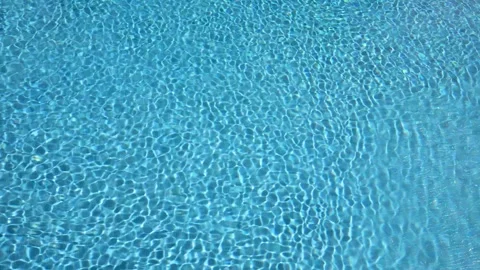 Clear Blue Pool Water with Sunlight Reflections and Ripple Patterns. Stock Footage 275590970