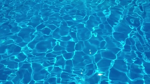 Clear Blue Pool Water Surface with Sunlight Reflections Stock Footage 276838256