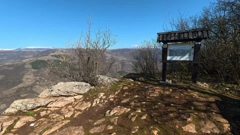 Clear blue sky above bare trees and distant hills. Balkan, Eastern Europe, POV Video stock 331815271