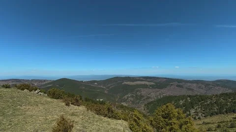 Clear blue sky above rolling green hills. Balkan, Eastern Europe, POV Video stock 333440824