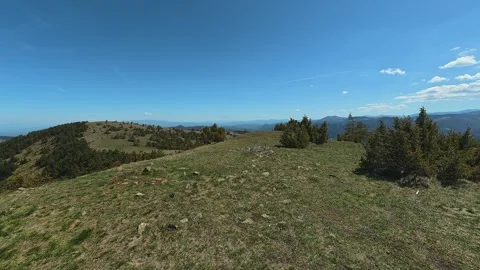 Clear blue sky above rolling green hills. Balkan, Eastern Europe, POV Video stock 333441517