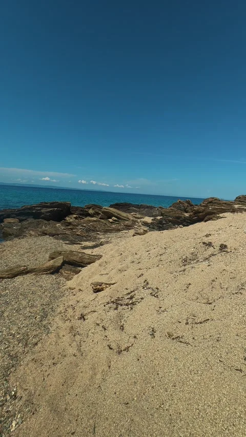 Clear blue sky above turquoise waters. Lagomandra, Greece. Vertical Stock Footage 339626297
