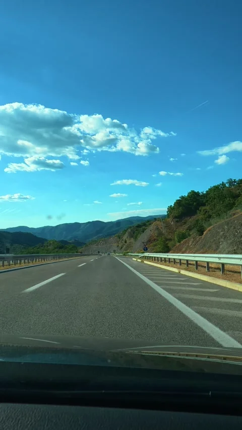 Clear blue sky above winding highway. Macedonia, Vertical Stock Footage 340652311