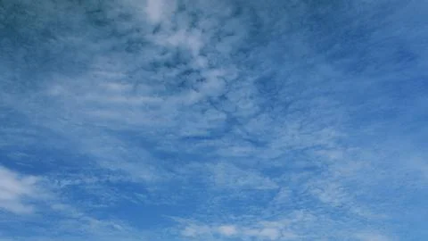 A Clear Blue Sky adorned with Fleeting Wispy Clouds that create a serene atmosph Stock Photos