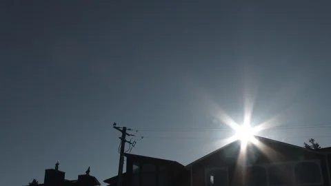 Clear Blue Sky And Sun Over Houses Zoom Out Video stock 121376707