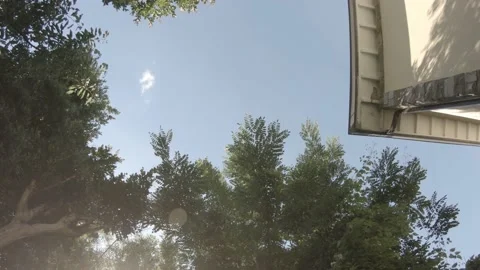 Clear blue sky and trees branches and a house. Stock Footage 156591688