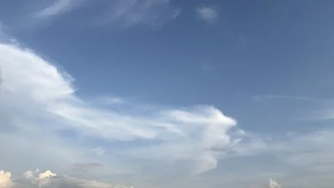 A clear blue sky featuring large white cloud formations during daylight Stock Photos