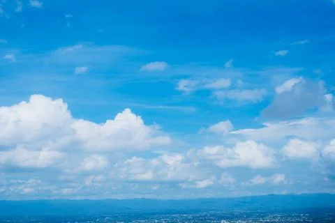 A clear blue sky with a few clouds Stock Photos