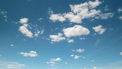 A Clear Blue Sky filled with Fluffy White Clouds, perfect for enjoying a serene Stock Photos