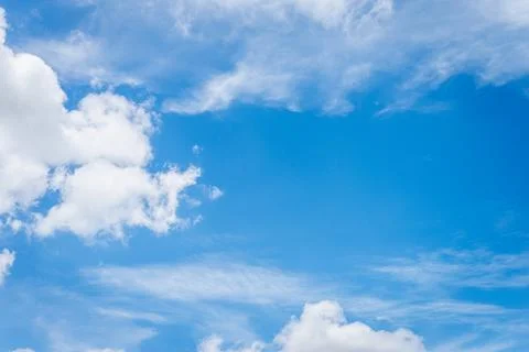Clear blue sky with fluffy clouds overhead outdoor landscape calm natural e.. Stock Photos