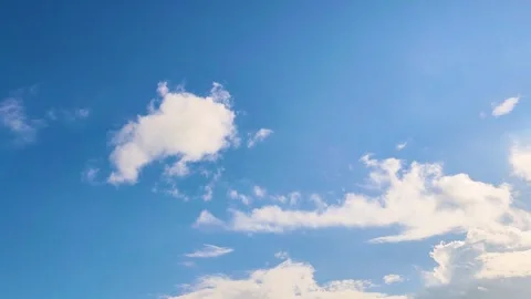 Clear Blue Sky with Fluffy White Cumulus Clouds on Bright Sunny Day Stock Footage 342874344