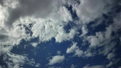 Clear Blue Sky with Fluffy White Clouds Background Stock Photos