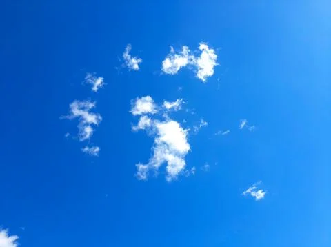 Clear Blue Sky With Fluffy White Clouds During a Sunny Day Stock Photos