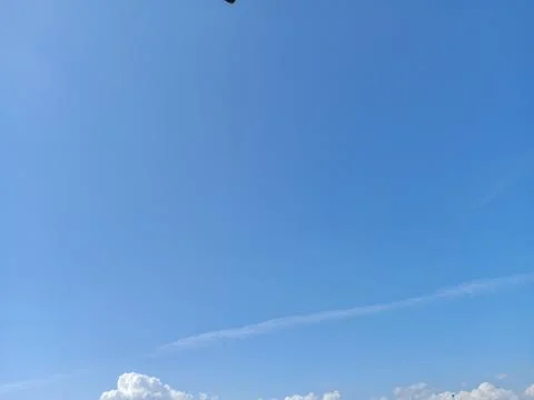 Clear Blue Sky with Light Soft White Clouds on a Sunny Day Photos